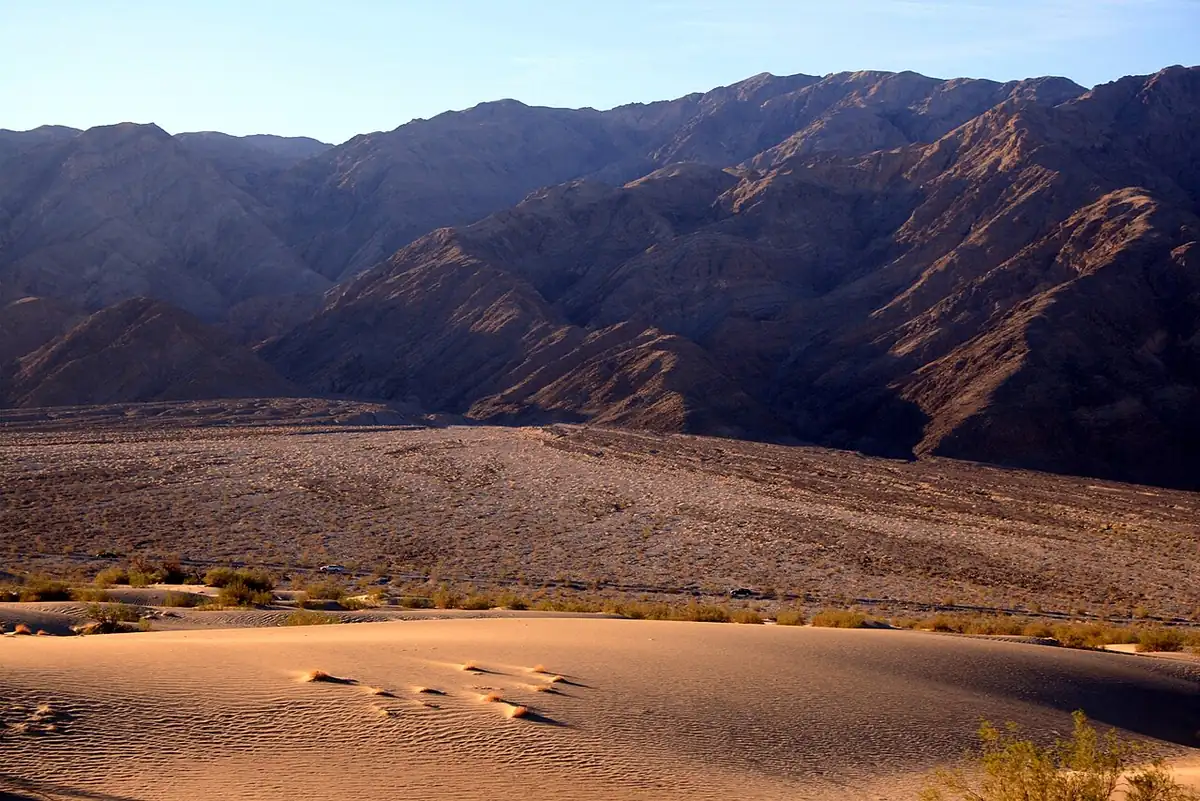 Empty warm colored desert basin and mountains in Death Valley.