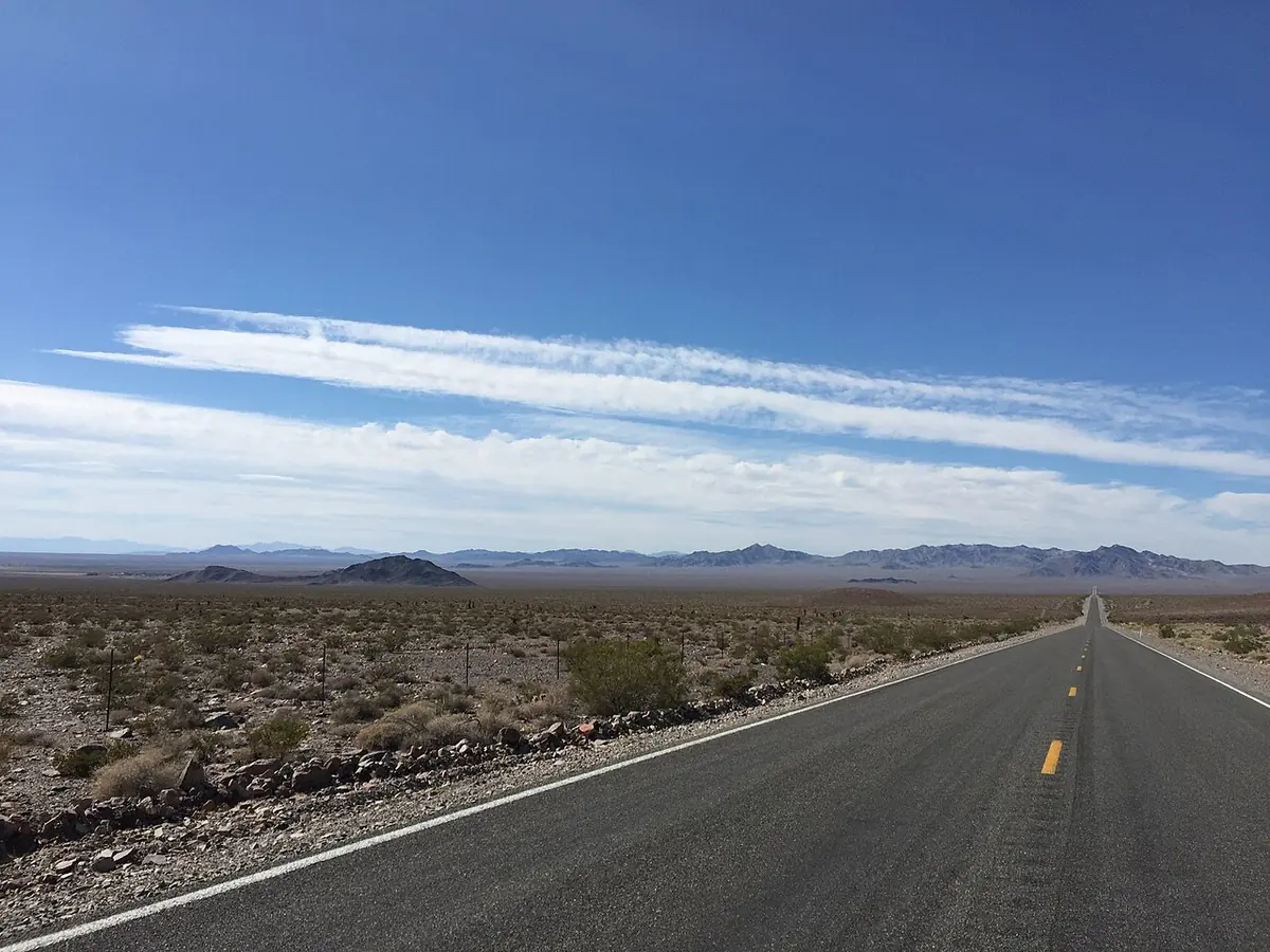 An empty highway running northwest out of Pahrump into open desert.