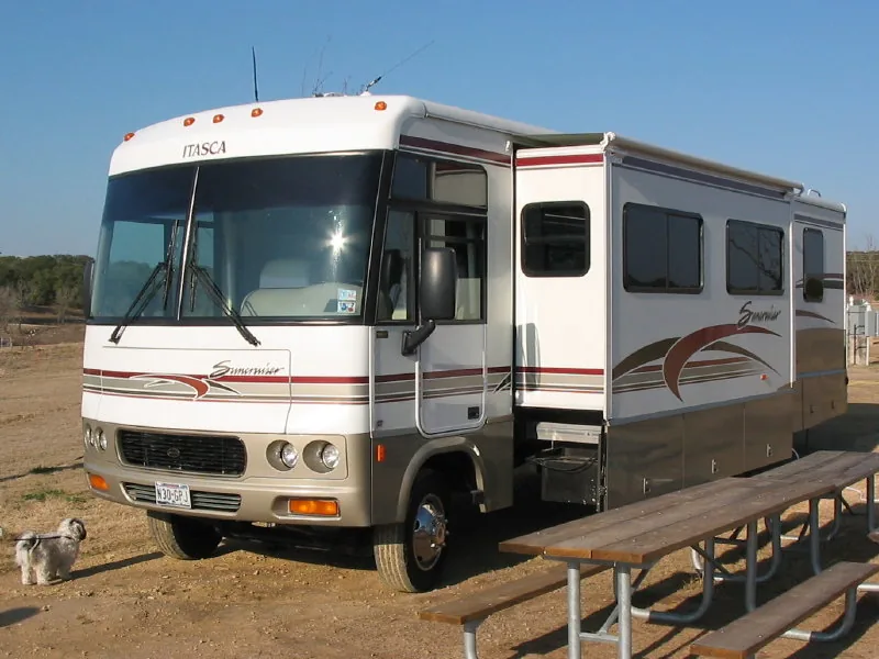 A Class A motorhome parked with its slide out room extended.