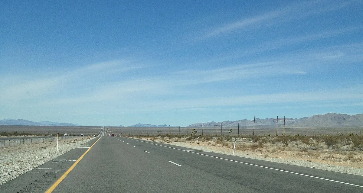 State Route 160 running across the open Pahrump Valley toward distant mountains.